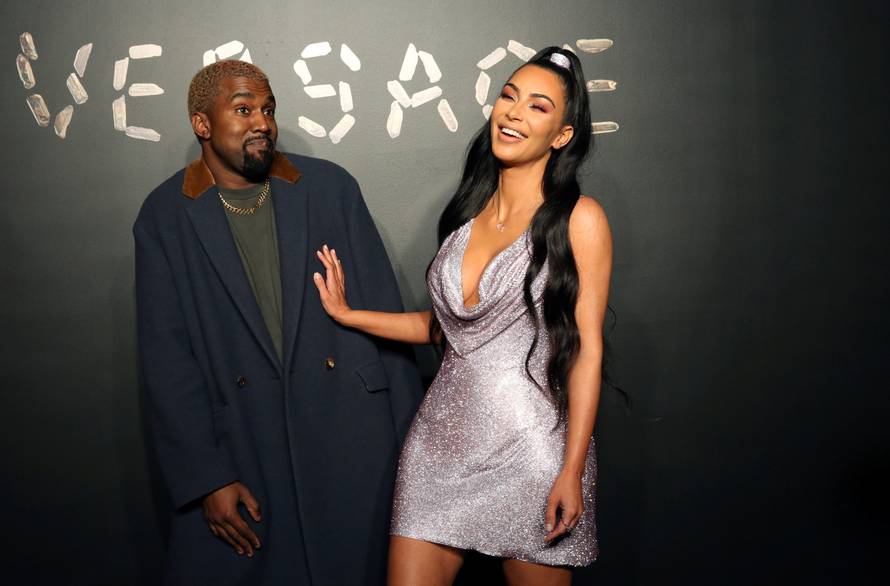 Kanye West and Kim Kardashian pose for a photo before attending the Versace presentation in New York