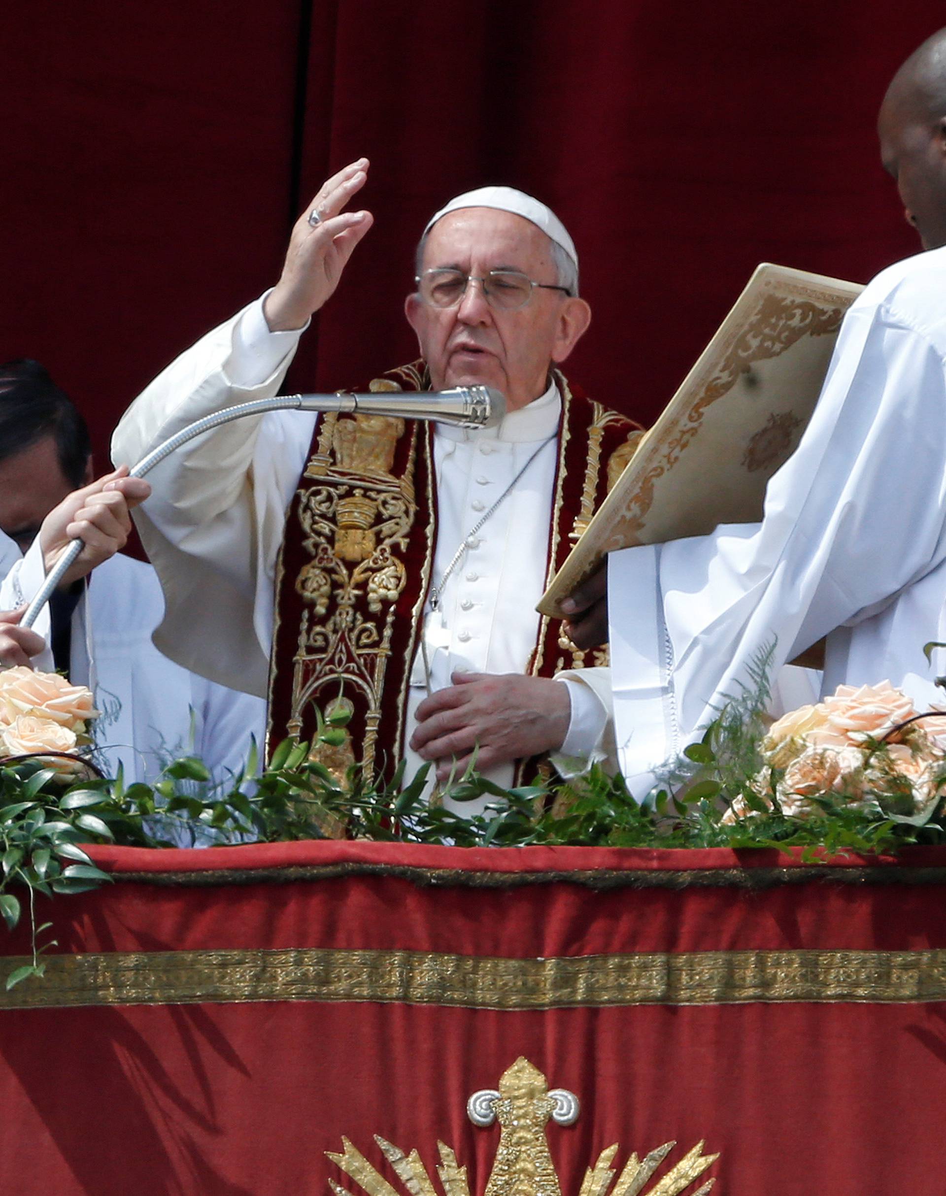 Pope Francis blesses the faithful during his "Urbi et Orbi" (to the city and the world) message from the balcony overlooking St. Peter's Square at the Vatican
