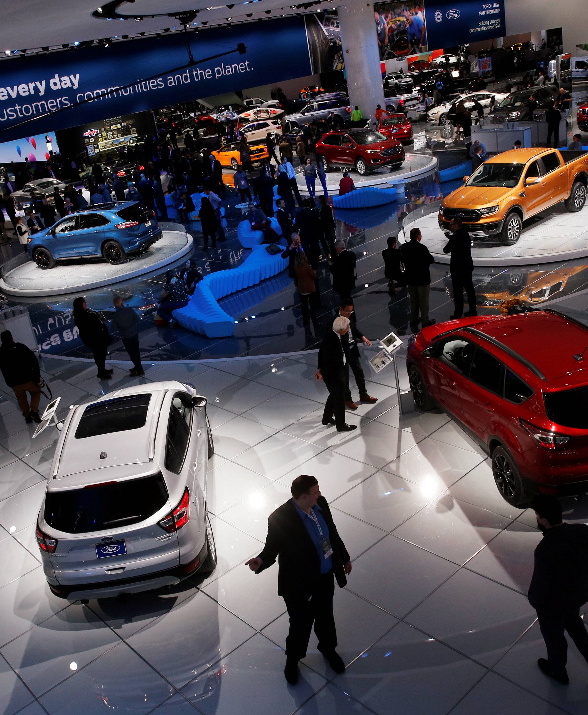 Reporters and guests visit the North American International Auto Show in Detroit