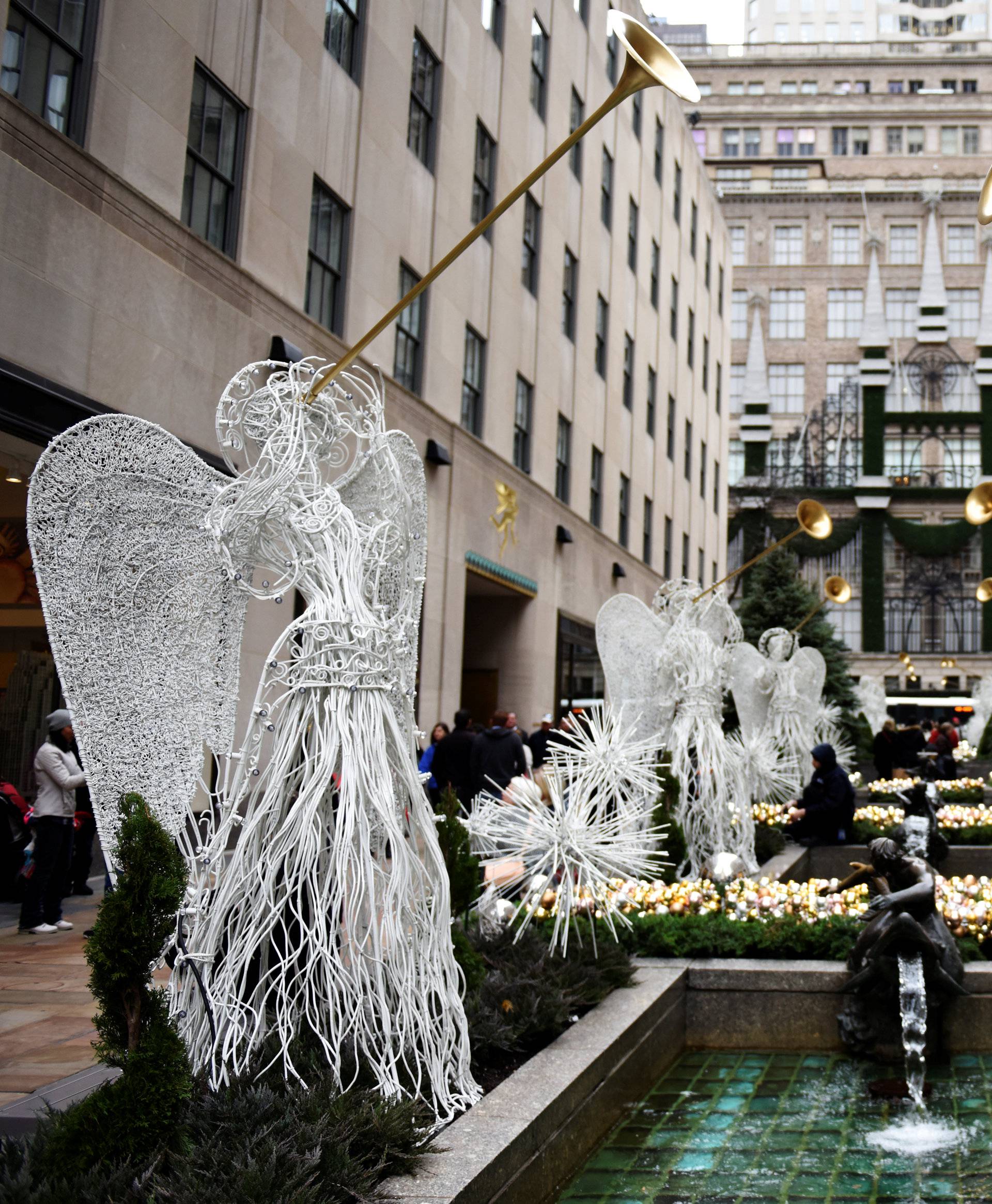 A worker adjusts a holiday installation at Rockefeller Center along Fifth Avenue in the Manhattan borough of New York