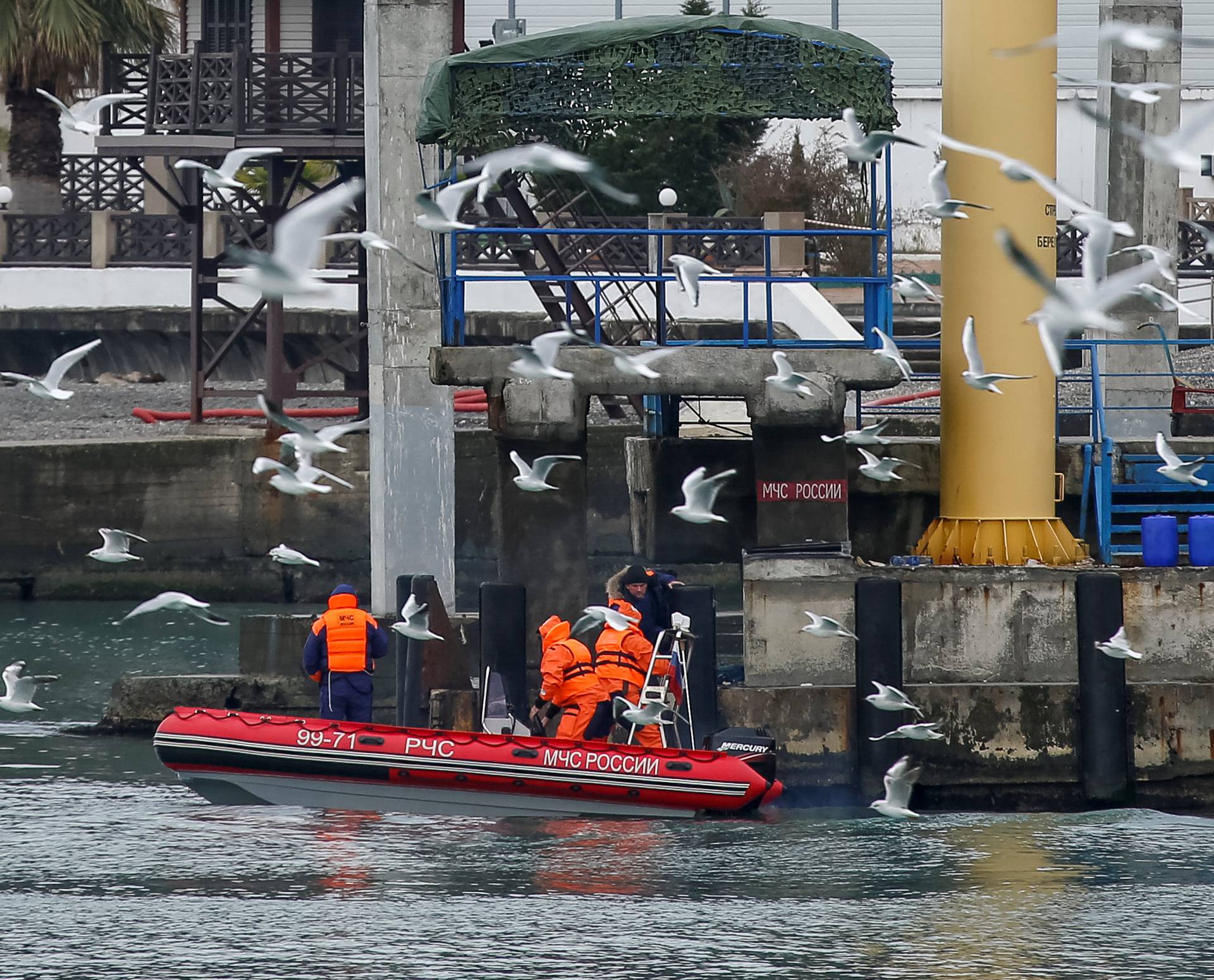 A boat of Russian Emergencies Ministry is seen near a pier, as rescue personnel conduct a search after a Russian military Tu-154 plane crashed into the Black Sea on its way to Syria on Sunday, in the Black Sea resort city of Sochi