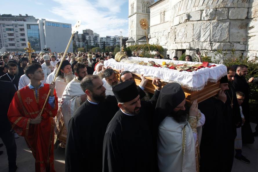 Priests carry the coffin of Metropolitan Amfilohije Radovic in Podgorica
