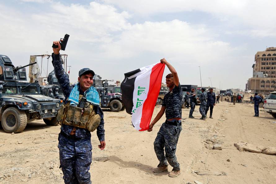 Iraqi Federal Police celebrate in the Old City of Mosul