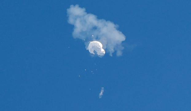 The suspected Chinese spy balloon drifts to the ocean after being shot down off the coast in Surfside Beach