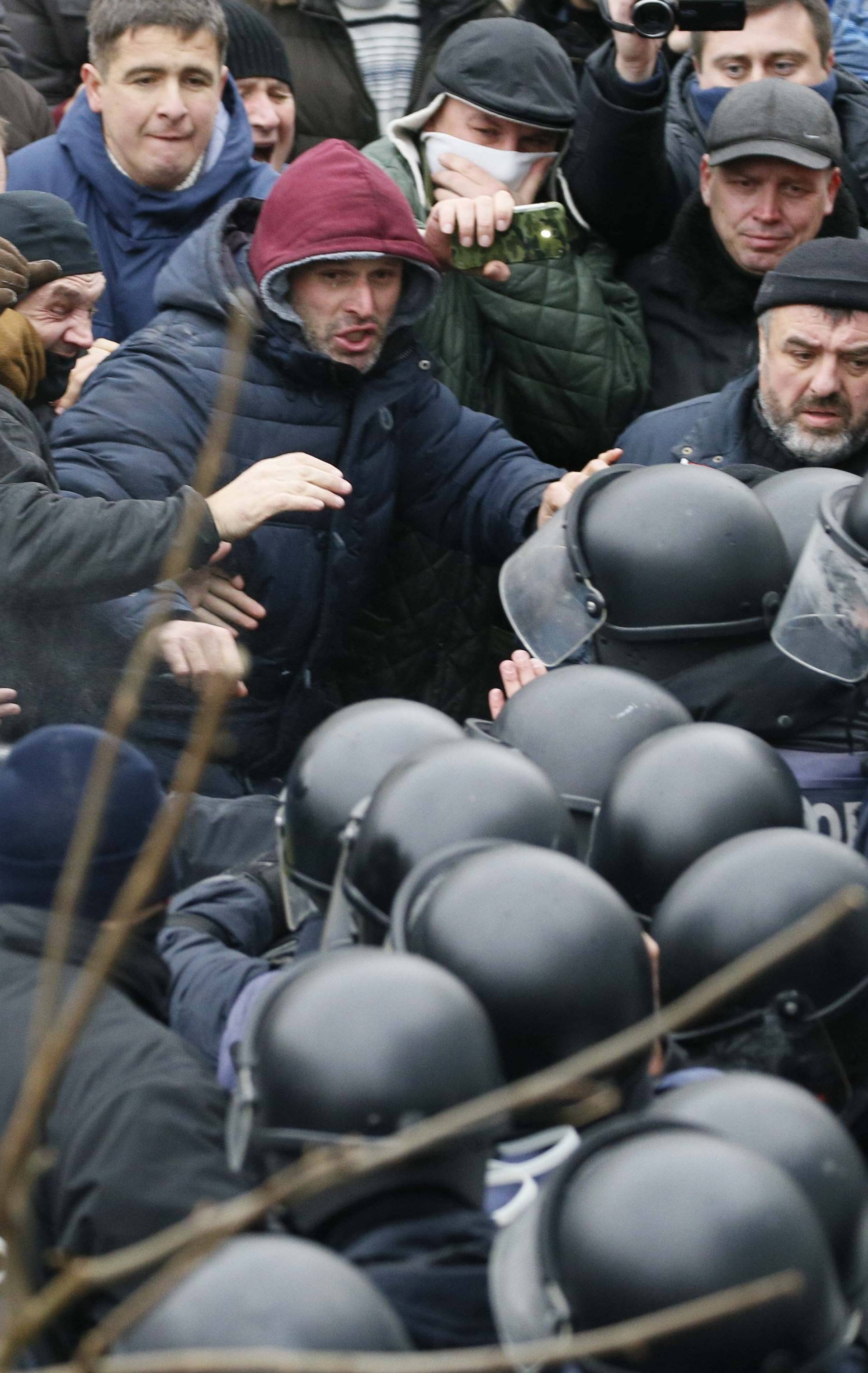 Police officers use tear gas against supporters of Georgian former President Mikheil Saakashvili during clashes in Kiev