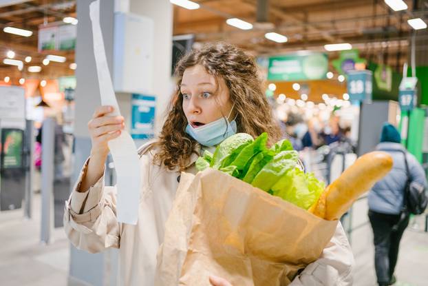 Young,Woman,In,A,Medical,Mask,Looks,Shocked,At,A