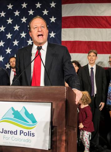 Democratic gubernatorial candidate Jared Polis reacts after appearing at his midterm election night party in Denver