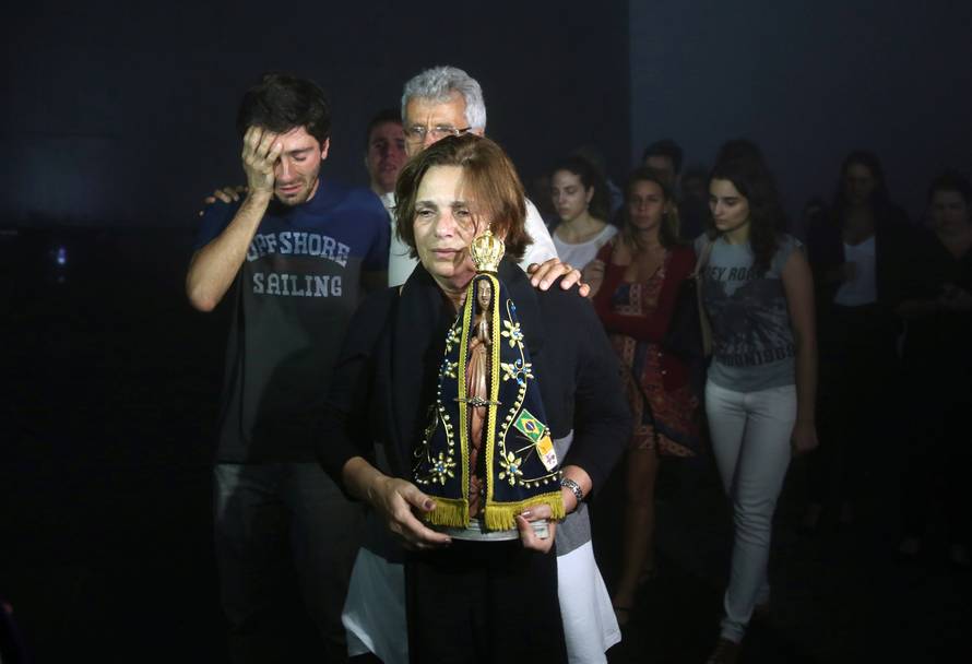 Relatives of Brazilian journalist Guilherme Marques mourn during a mass in Rio de Janeiro