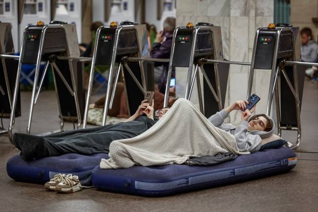 People take shelter inside a metro station during an air raid alert in Kyiv