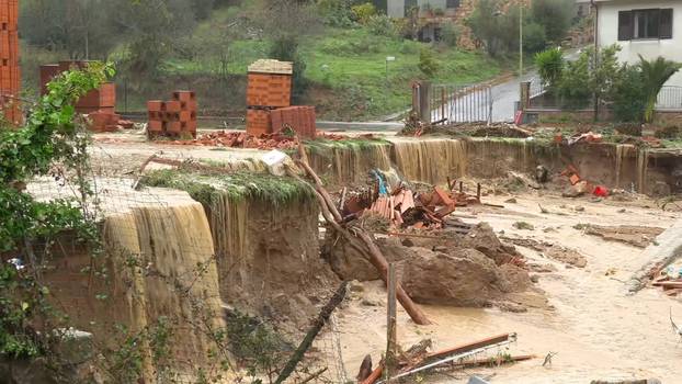 Still image taken from video shows town of Bitti affected by flash floods