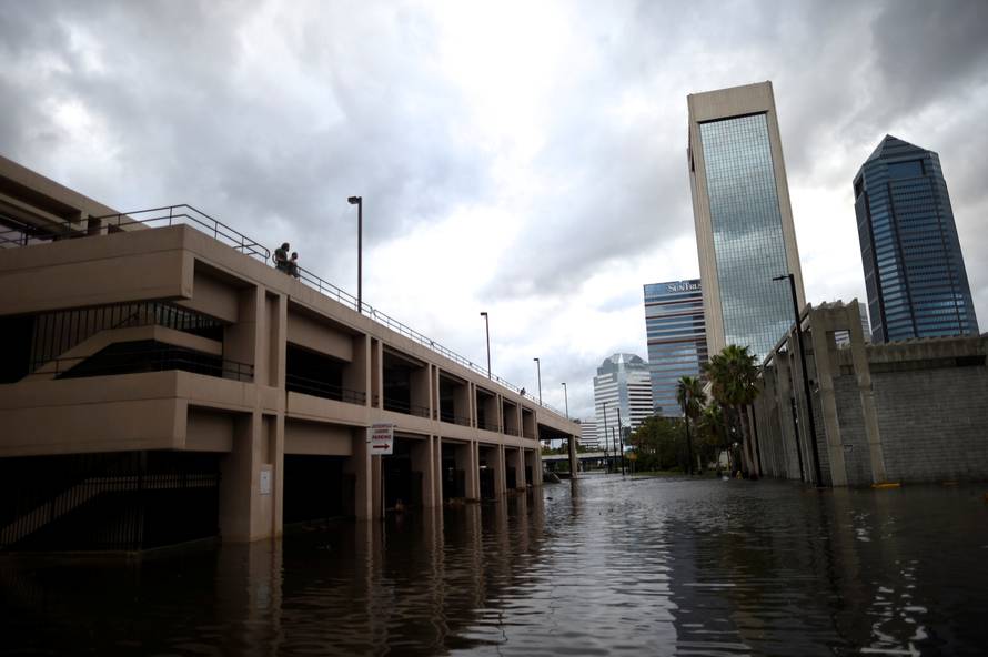 A couple overlooks floodwaters after Hurricane Irma