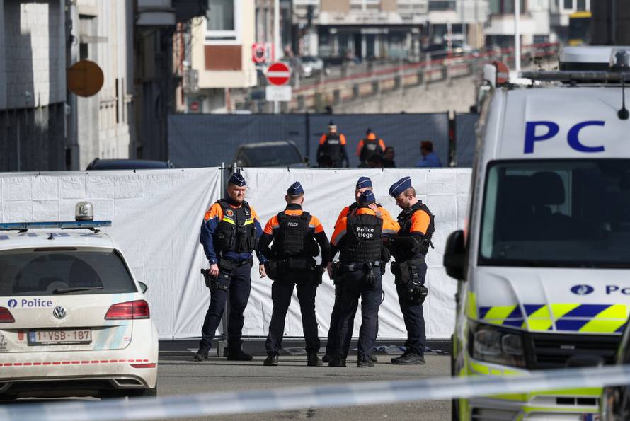 Police secure the site near a synagogue damaged by an explosion in Liege