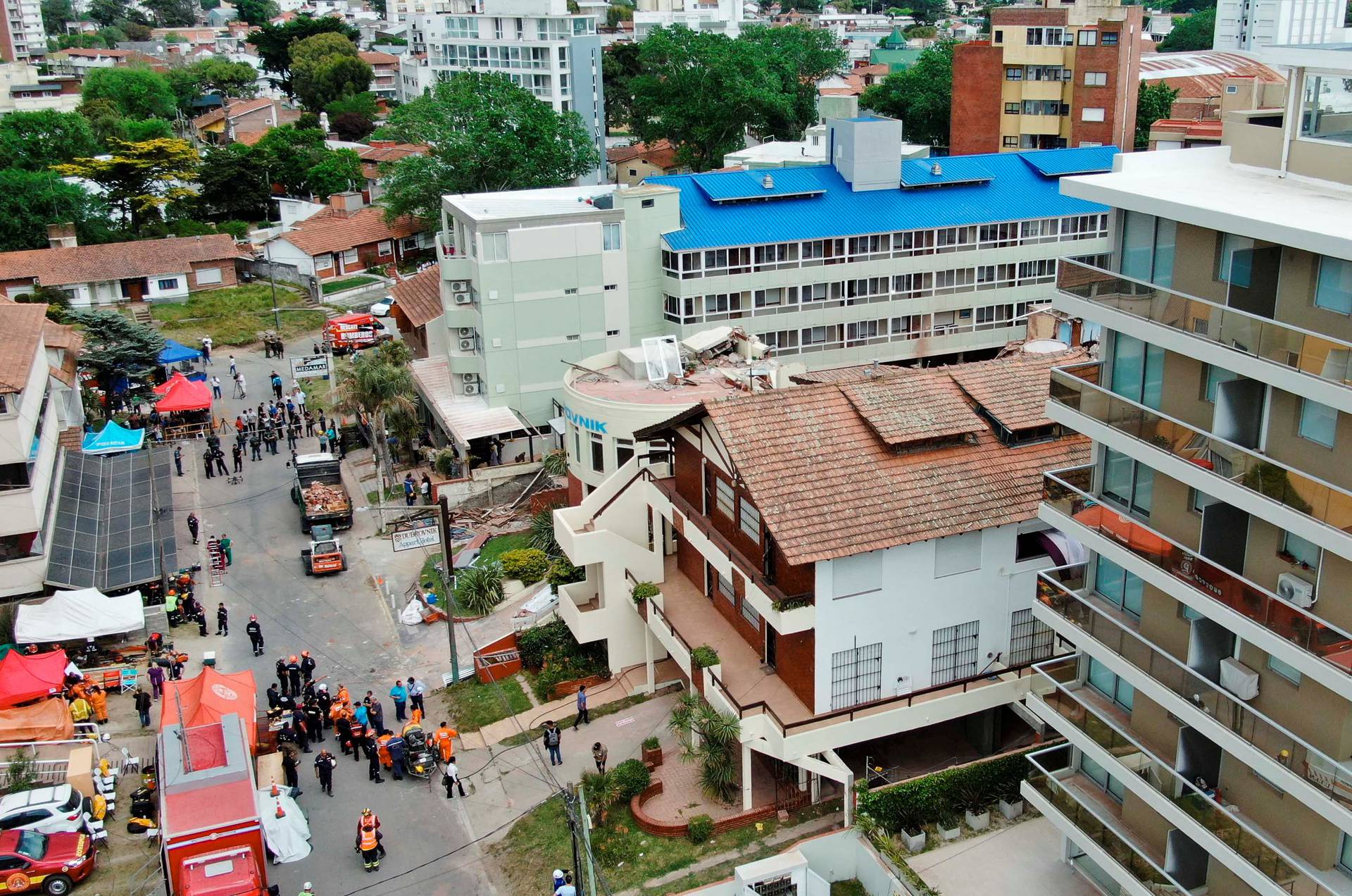 Firefighters search for trapped people after a hotel collapses in Villa Gesell