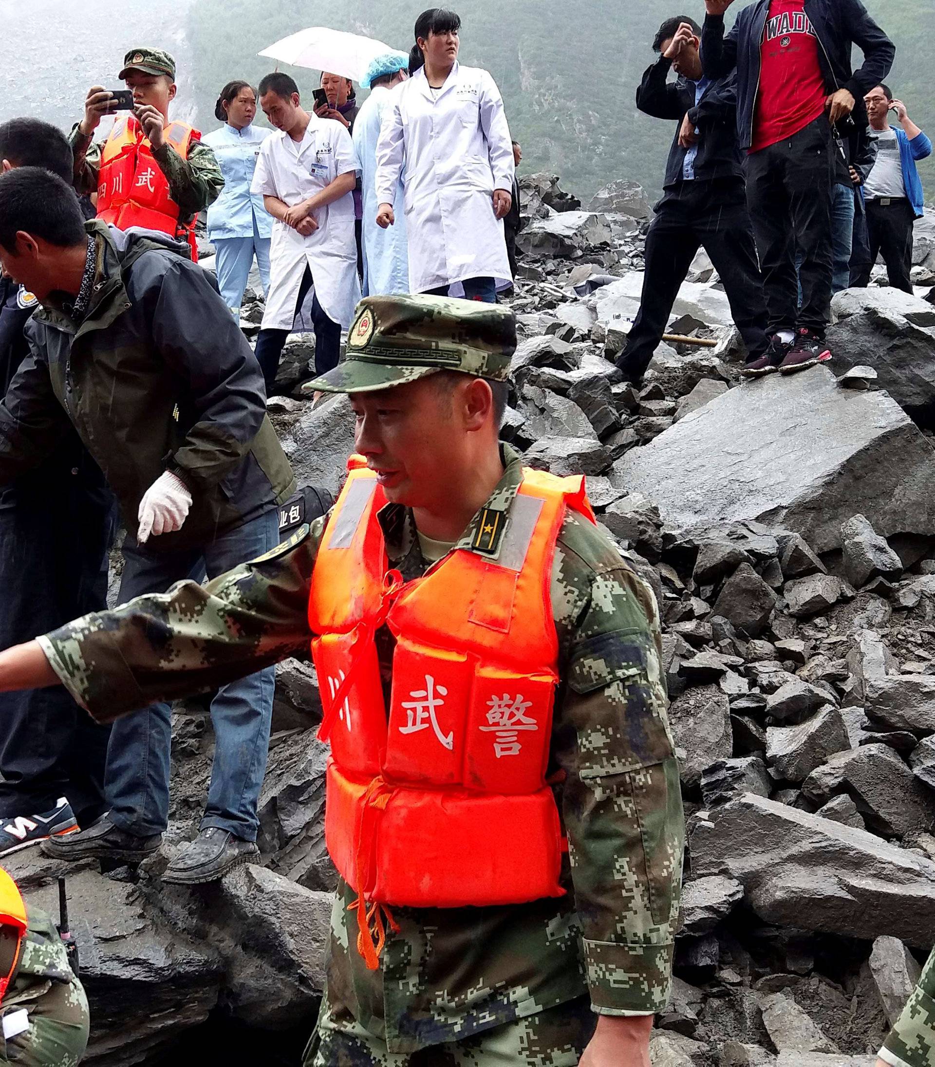 People search for survivors at landslide site that occurred in Xinmo Village