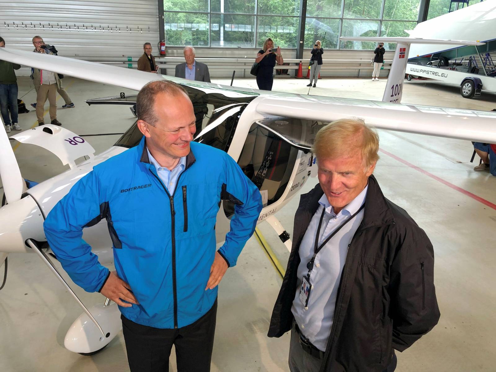 FILE PHOTO: Norwegian Transport Minister Ketil Solvik-Olsen and head of the Avinor Dag Falk-Petersen stand next to a two-seat electric plane made by Slovenian company Pipistrel at Oslo Airport