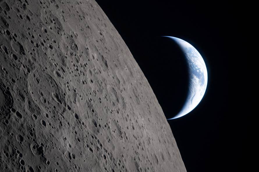 A view of Earth, partially hidden by the Moon, photographed through the Orion spacecraft window