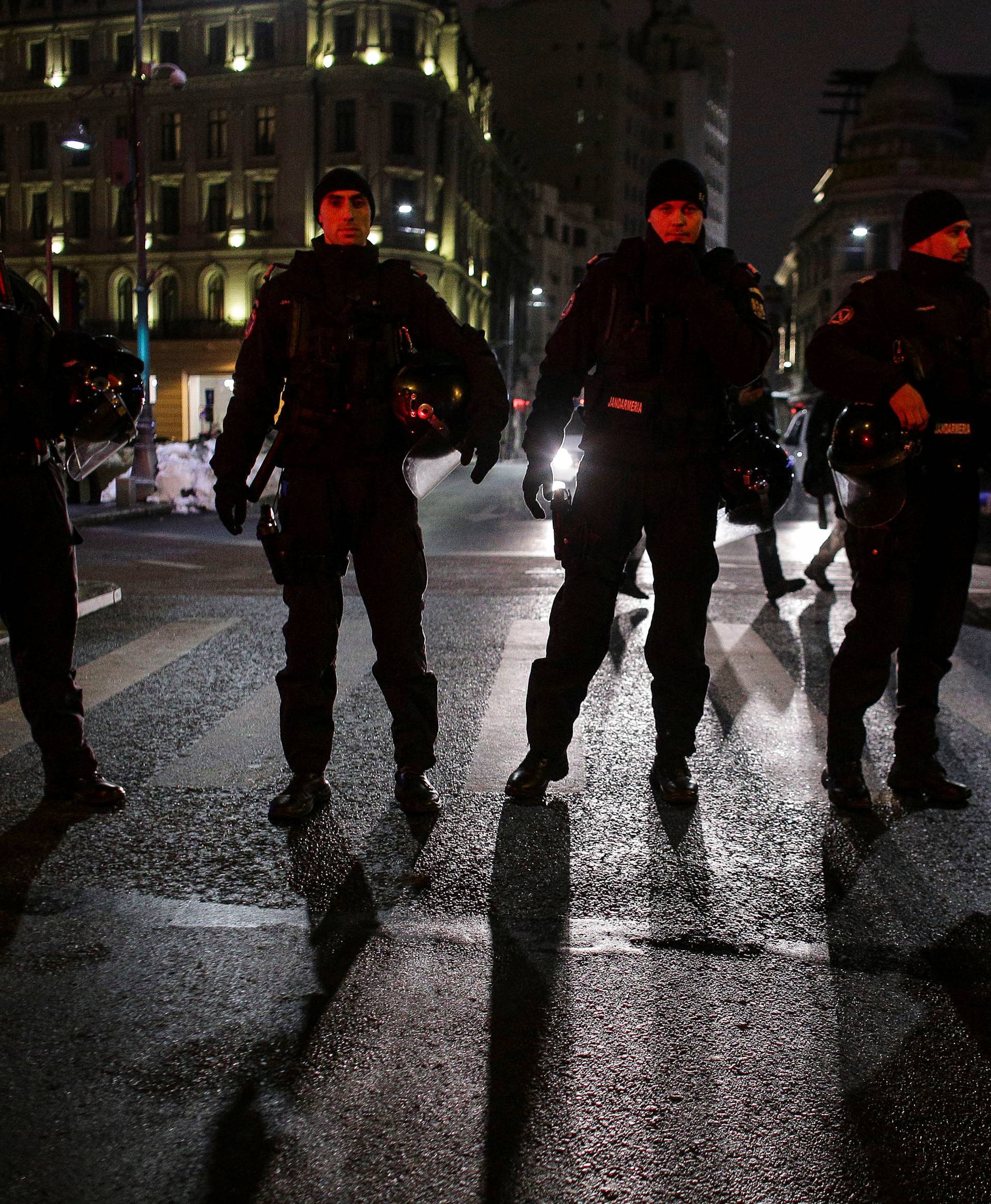 Romanian police stand guard during a demonstration  against government plans to reform some criminal laws through emergency decree, in Bucharest