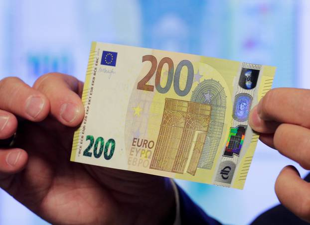 An Austrian central bank official displays a new 200 euro banknote in Vienna