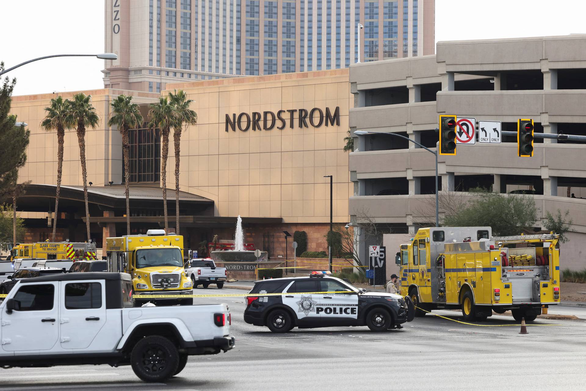 Firefighters work at the Tesla Cybertruck which burned at the entrance of Trump Tower in Las Vegas