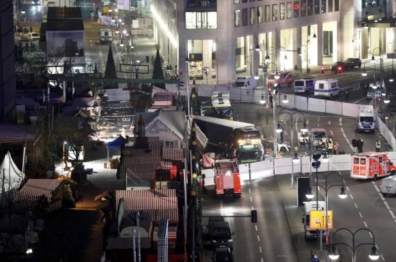 A tow truck operates at the scene where a truck ploughed through a crowd at a Berlin Christmas market