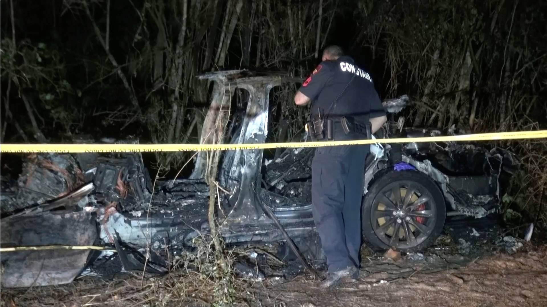 The remains of a Tesla vehicle are seen after it crashed in The Woodlands, Texas