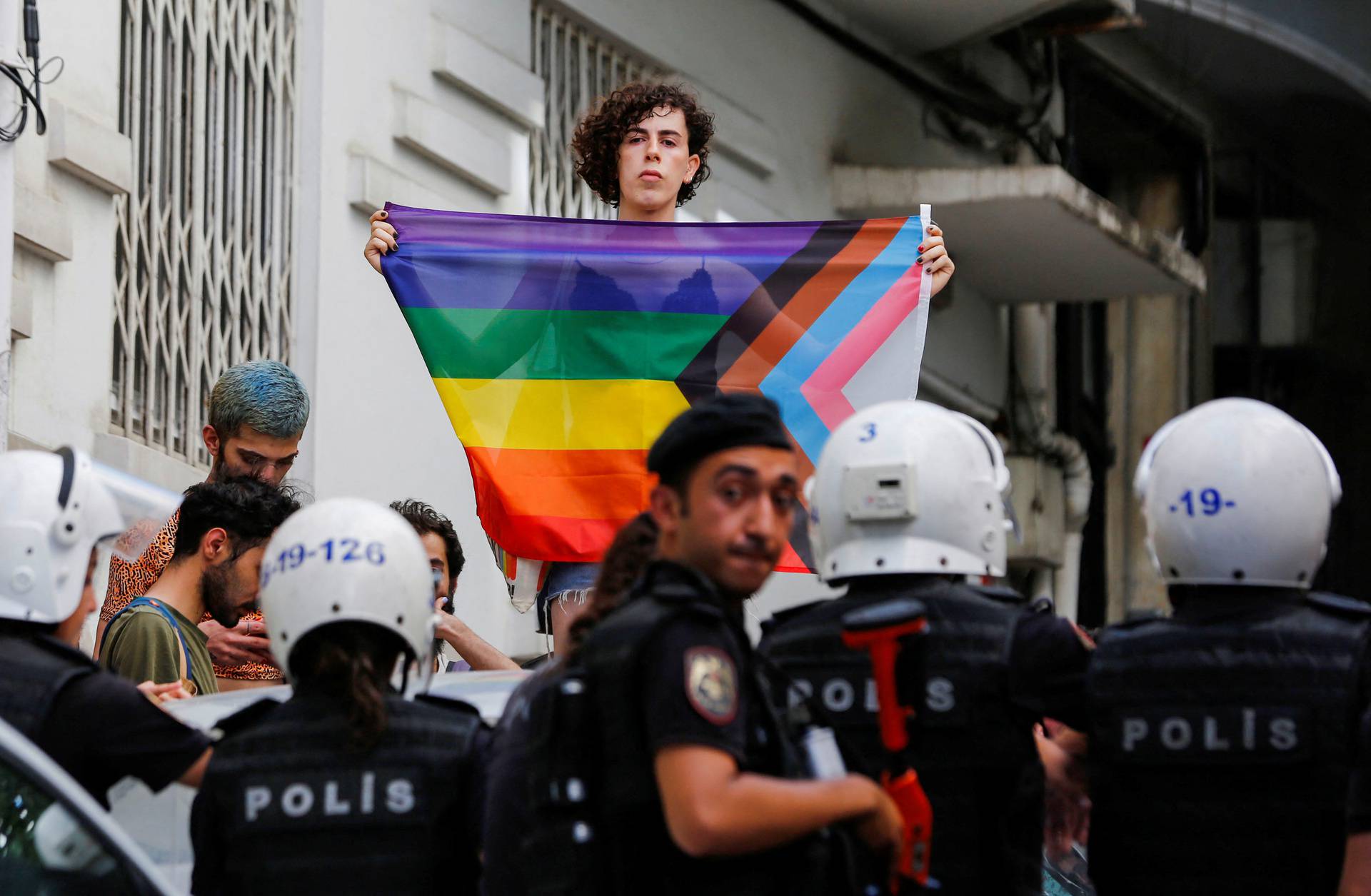 Demonstrators march as they try to gather for a pride parade in Istanbul