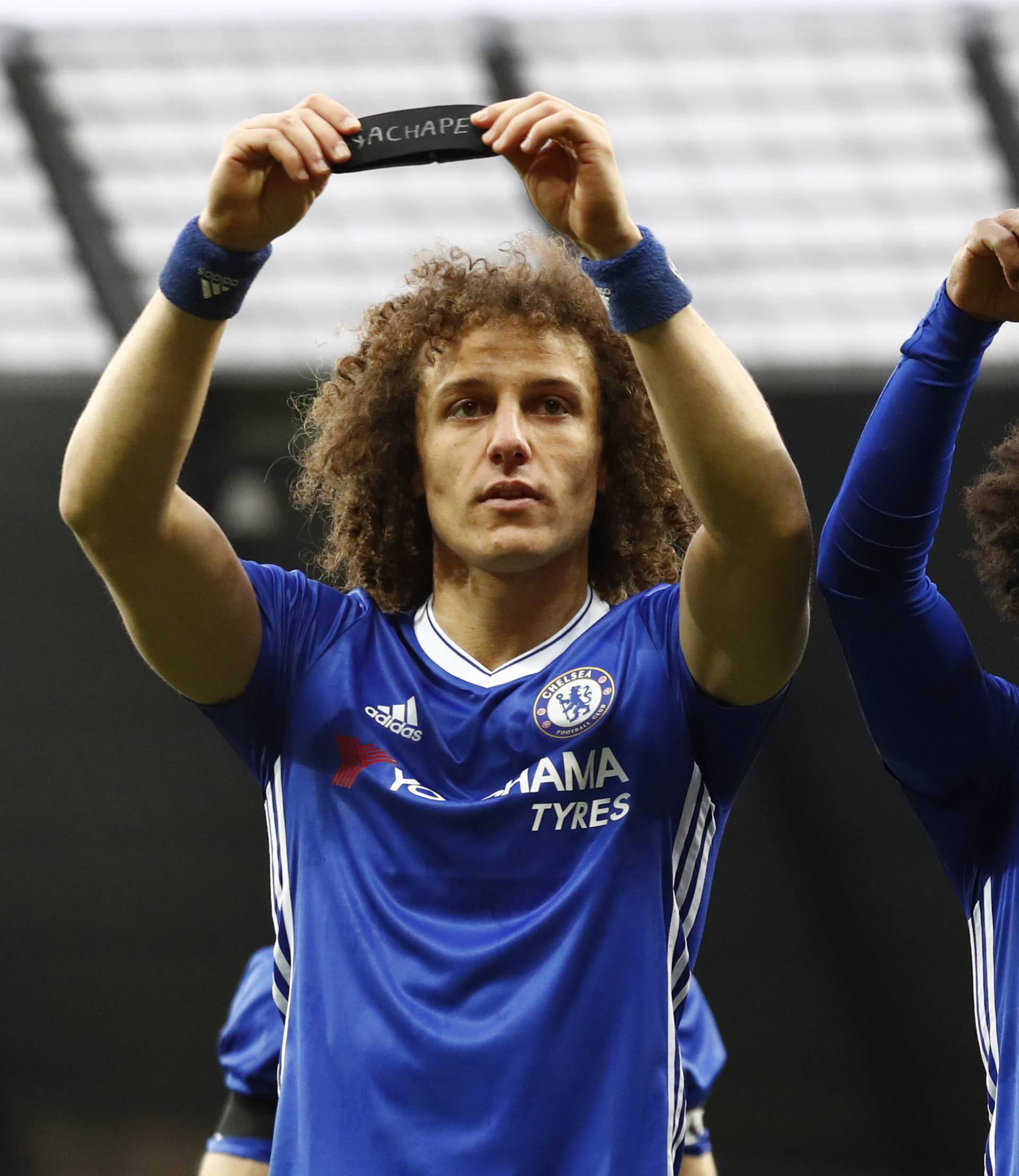 Chelsea's Willian celebrates scoring their second goal with David Luiz as they hold armbands in respect for the victims of the Colombia plane crash containing the Chapecoense players and staff