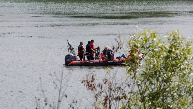 Rescue divers from the firefighter department patrol in search for lost Beluga whale, in Les Andelys