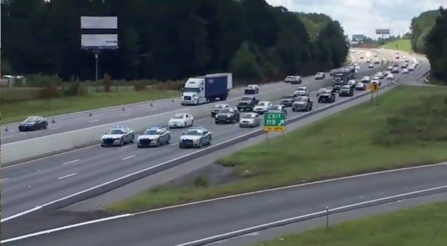 South Carolina Highway Patrol cars escort a line of vehicles as they lead traffic from Charleston to Columbia, as residents prepare ahead of Hurricane Florence's descent