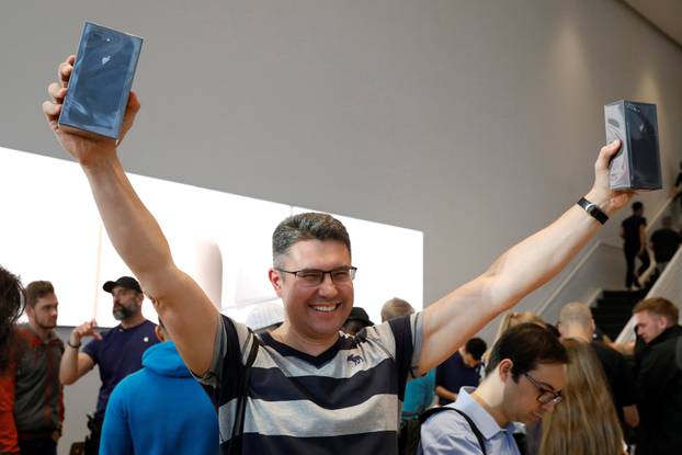 One of the first customers celebrates his purchase of the new iPhone 8 at the 5th Avenue Apple store in New York