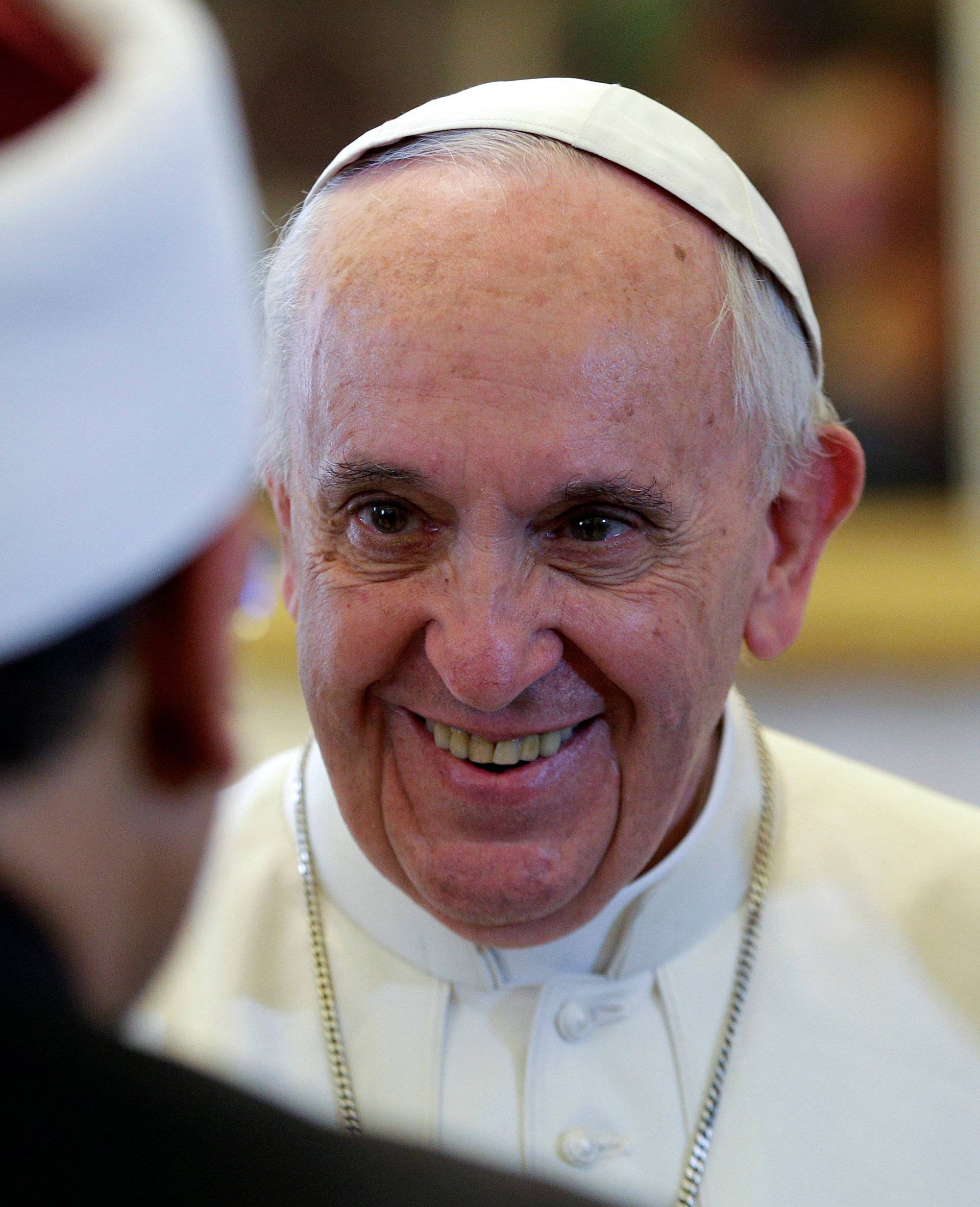 Pope Francis smiles to a member of the delegation as he meets with Sheikh Ahmed Mohamed el-Tayeb, Egyptian Imam of al-Azhar Mosque, at the Vatican