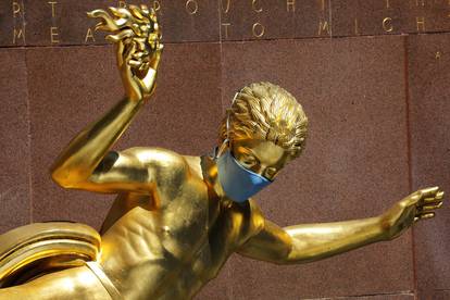 Prometheus statue at Rockefeller Center in Manhattan with face mask following outbreak of the coronavirus disease (COVID-19) in New York