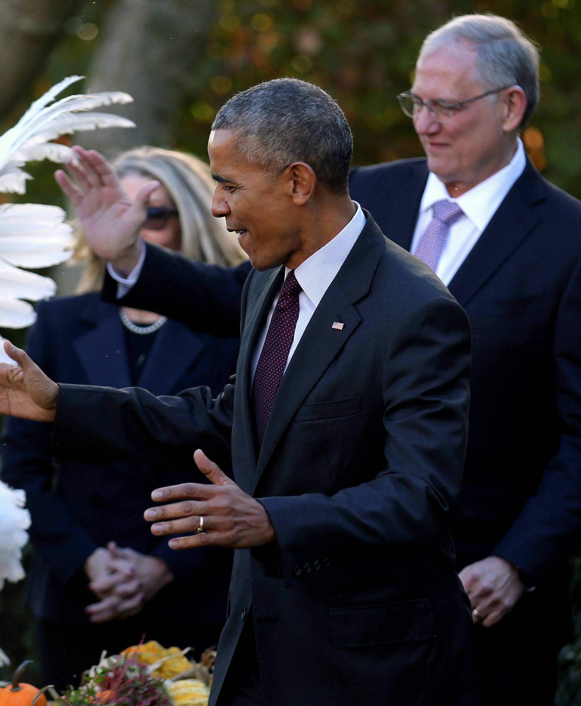 U.S. President Barack Obama reacts after pardoning the National Thanksgiving turkey during the 69th annual presentation of the turkey in the Rose Garden of the White House in Washington