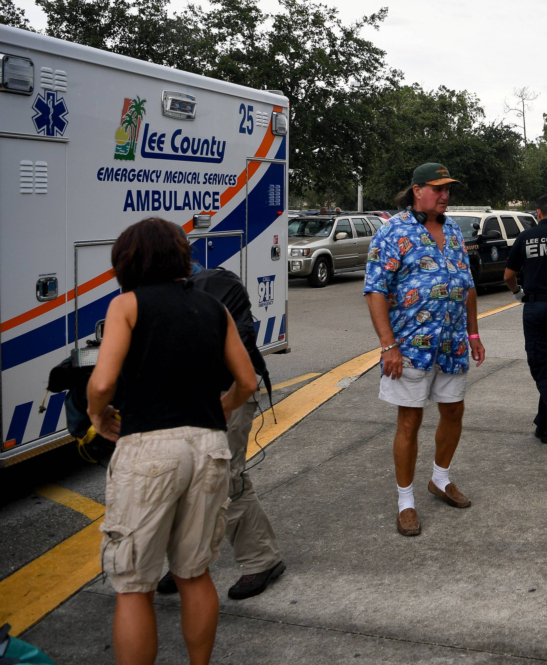 Emergency medical personnel move a woman from the Germain Arena hurricane shelter to an awaiting ambulance in Estero