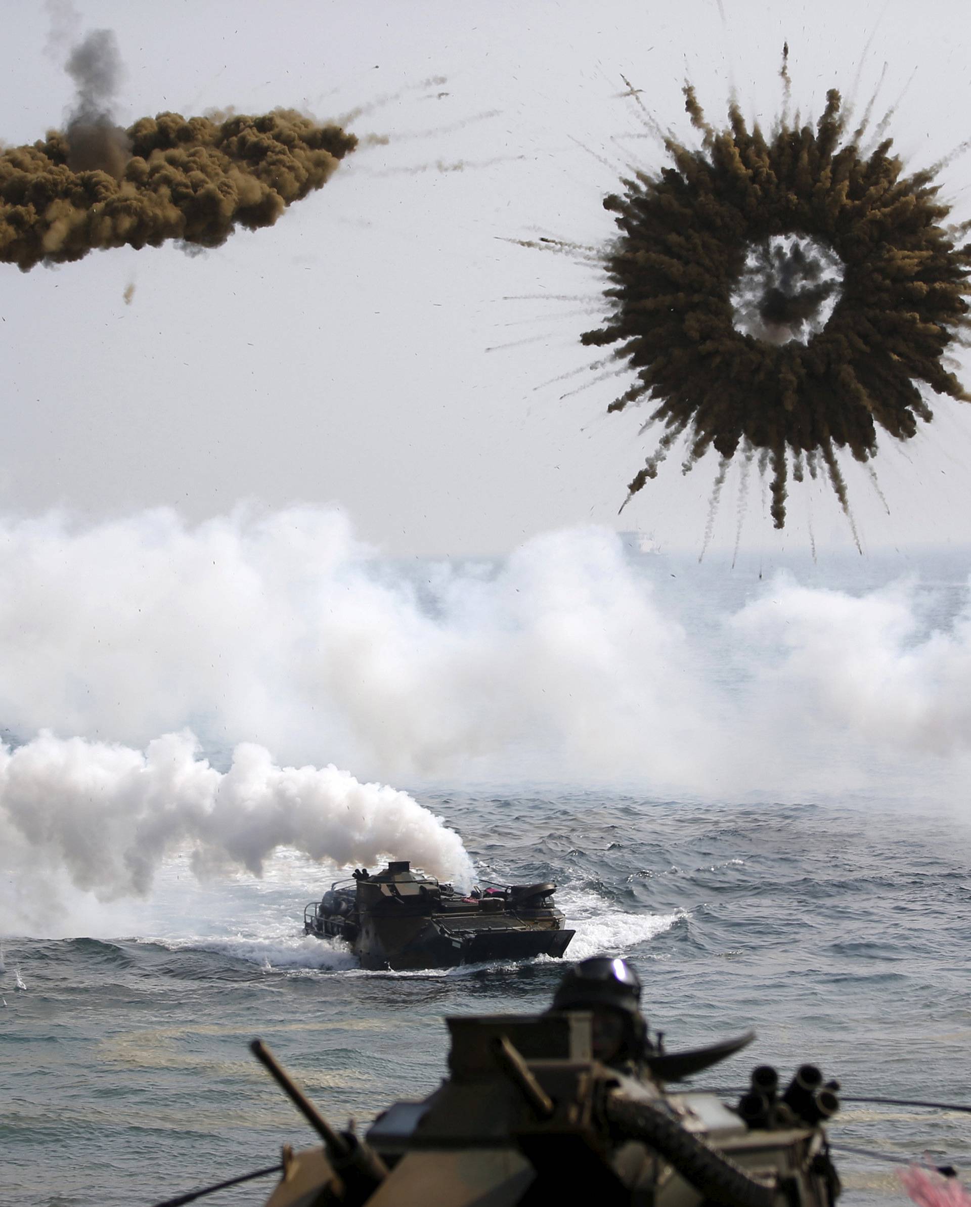FILE PHOTO: Amphibious assault vehicles of the South Korean Marine Corps throw smoke bombs as they move to land on shore during a U.S.-South Korea joint landing operation drill in Pohang