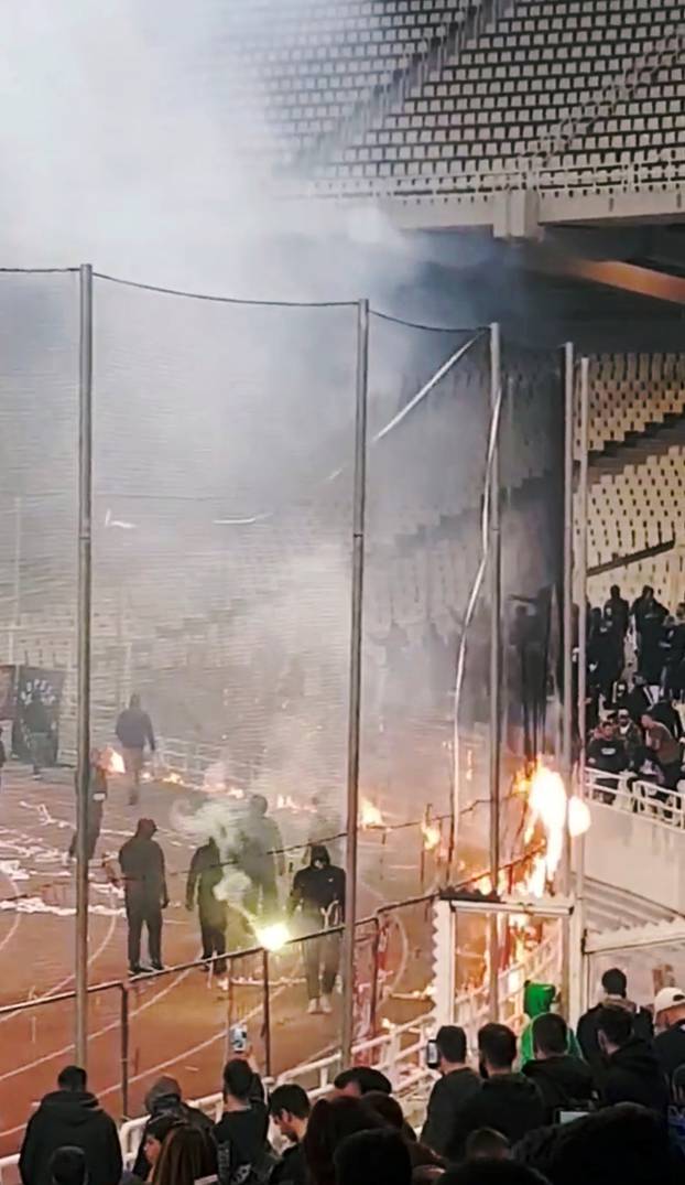 Panathinaikos fans burn flags during their Super League match at the OAKA Spiros Louis stadium in Athens