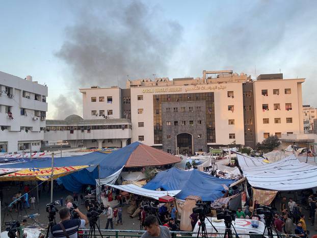 FILE PHOTO: Smoke rises as displaced Palestinians take shelter at Al Shifa hospital, amid the ongoing conflict between Hamas and Israel, in Gaza City