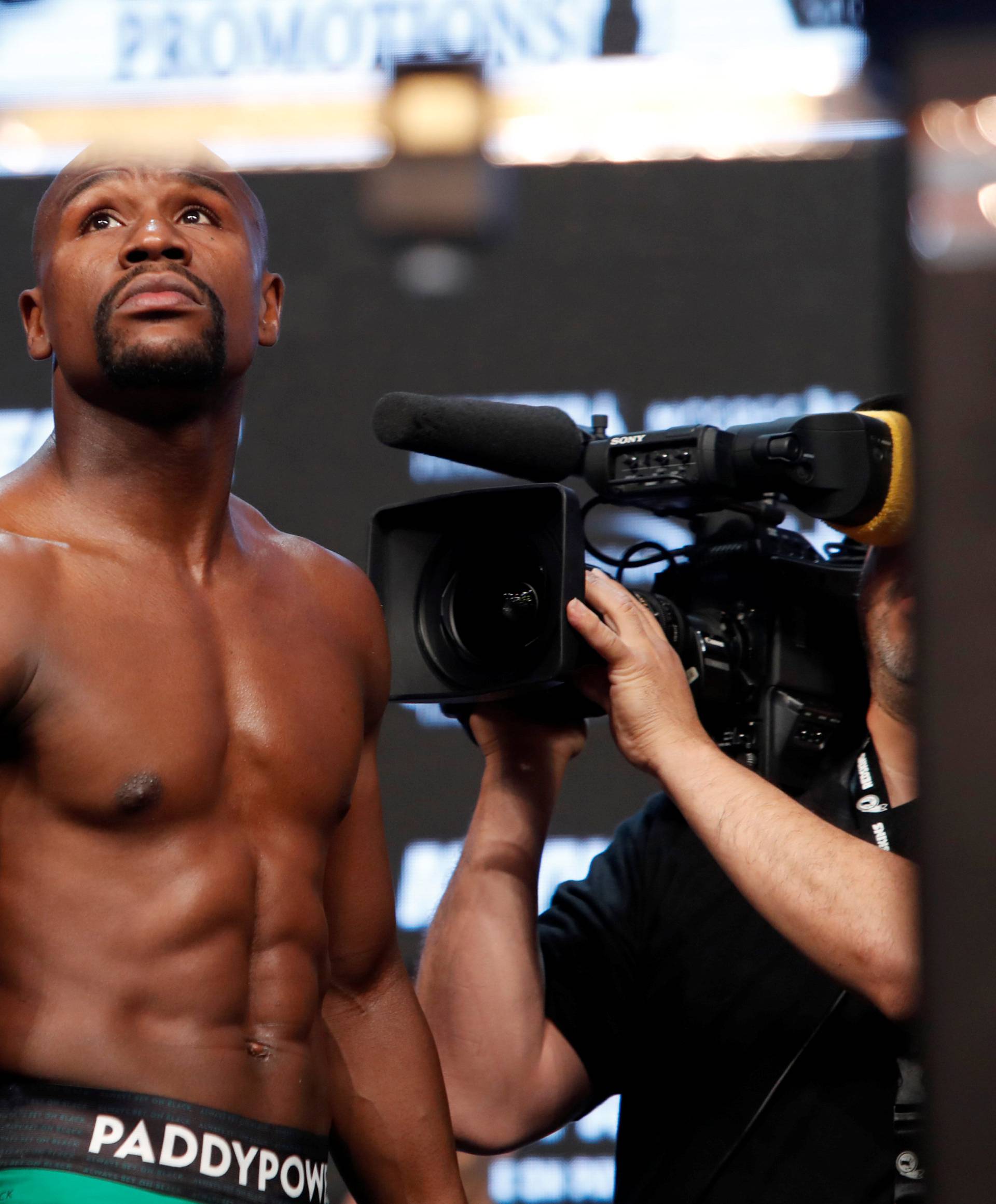 Undefeated boxer Floyd Mayweather Jr. of the U.S. walks by the scale during his official weigh-in at T-Mobile Arena in Las Vegas