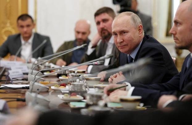 Russian President Vladimir Putin meets with war correspondents in Moscow