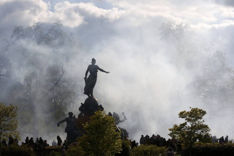 A cloud of tear gas is seen around the statue of the Place de la Nation during clashes between youth and police during a demonstration against the French labour law proposal in Paris