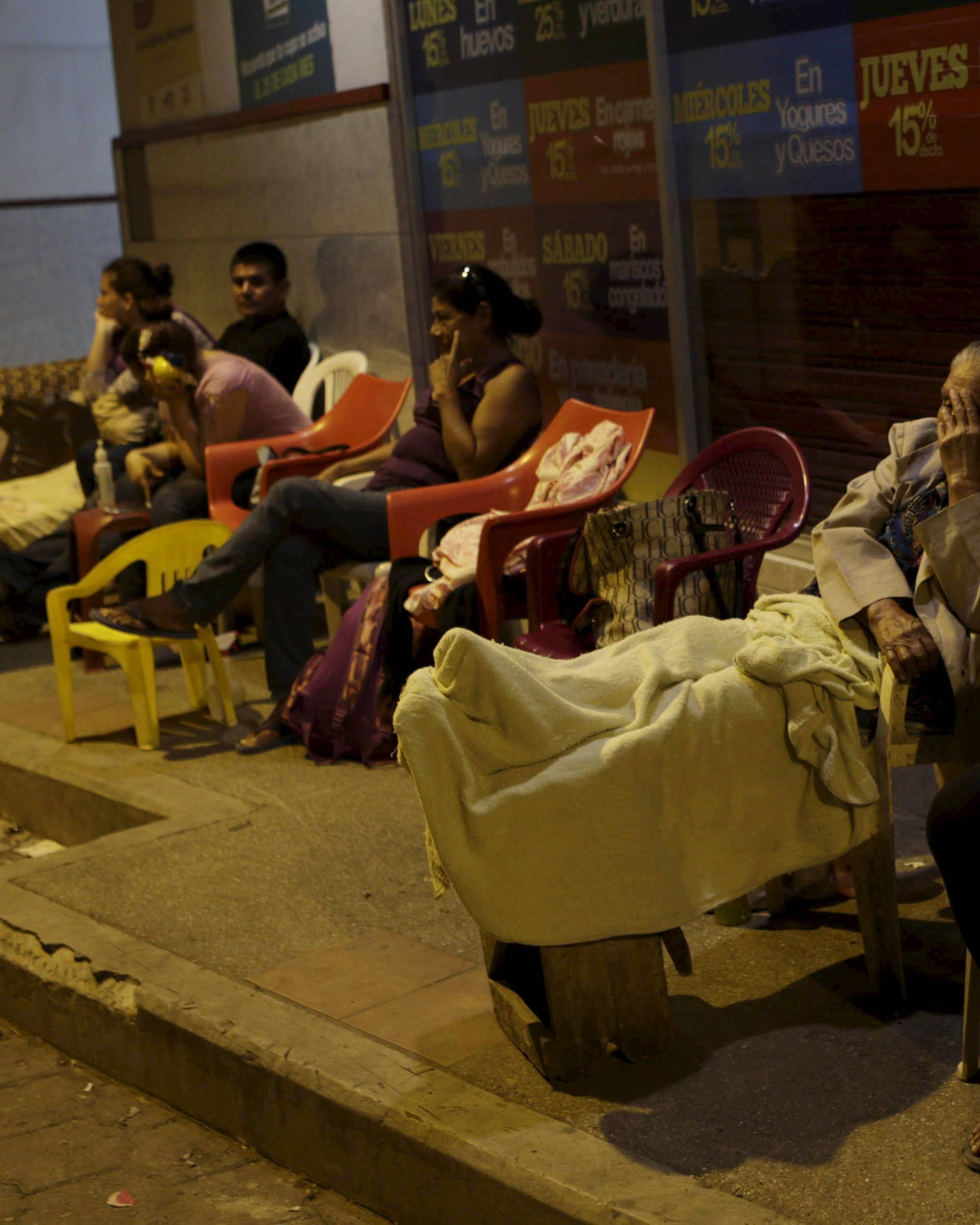 Residents rest outside their homes after an earthquake struck off the Pacific coast, in Portoviejo, Ecuador