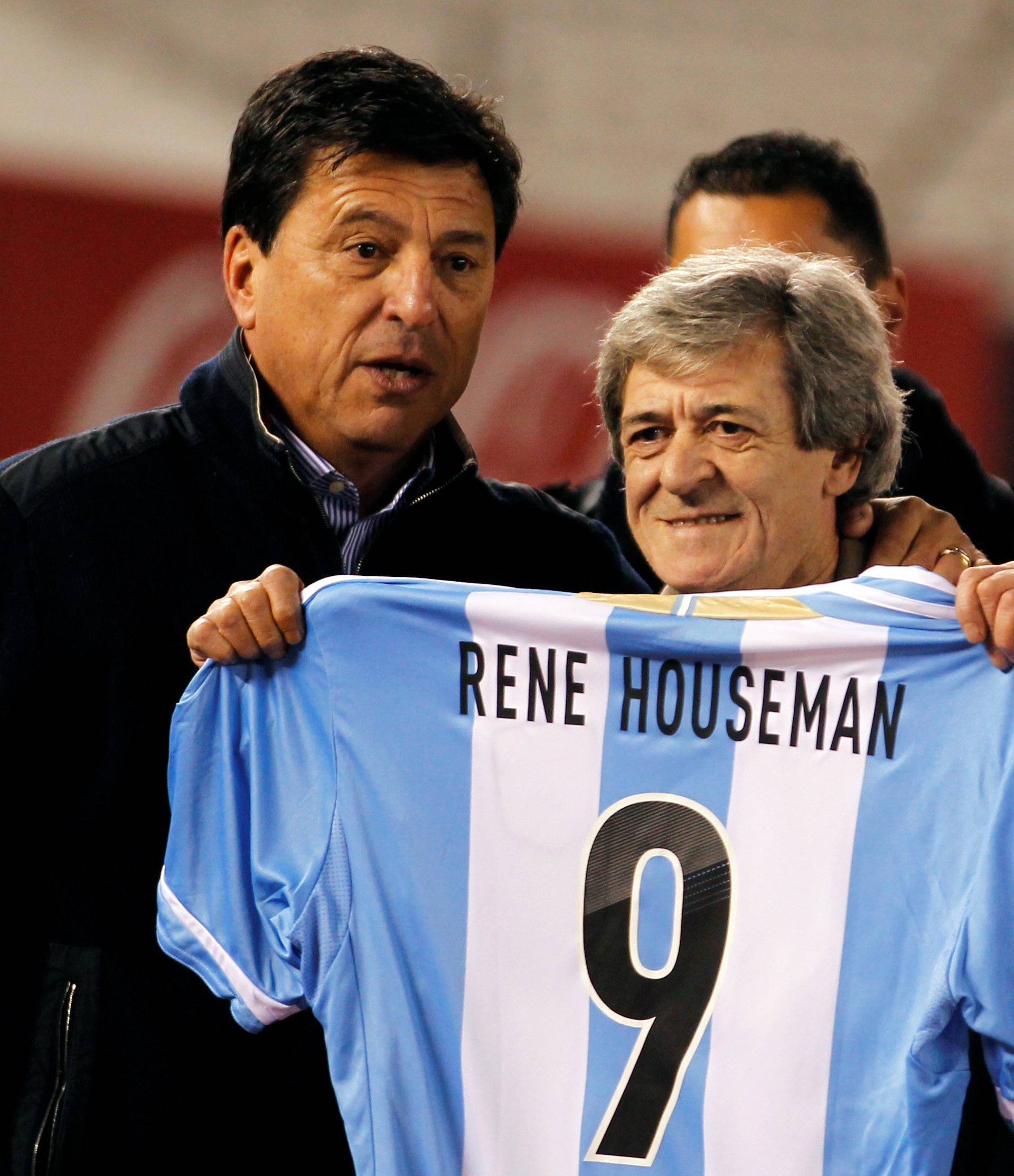 FILE PHOTO: Former soccer player Rene Houseman, who played in the 1978 World Cup, shows a jersey next his former team mate Daniel Passarella in Buenos Aires