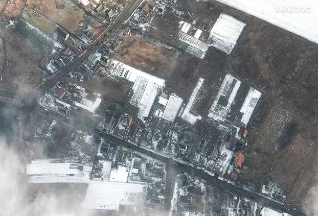 A satellite image shows armoured vehicles moving on a road northeast of Antonov Airport near Hostomel