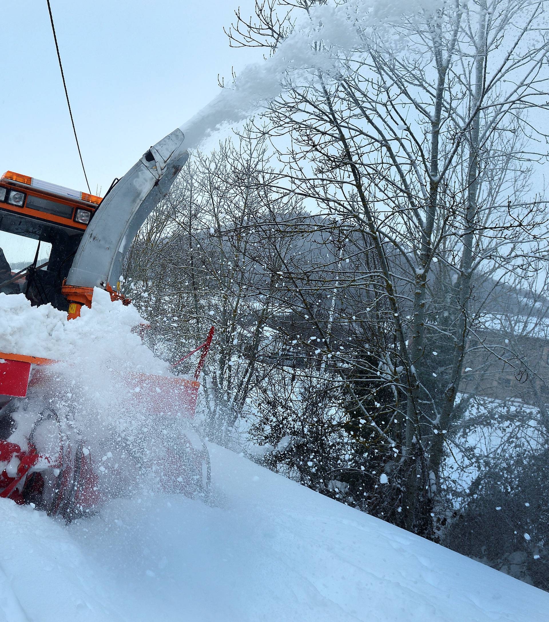 A snow clearing machine operates in the Cantabrian village of Fontibre
