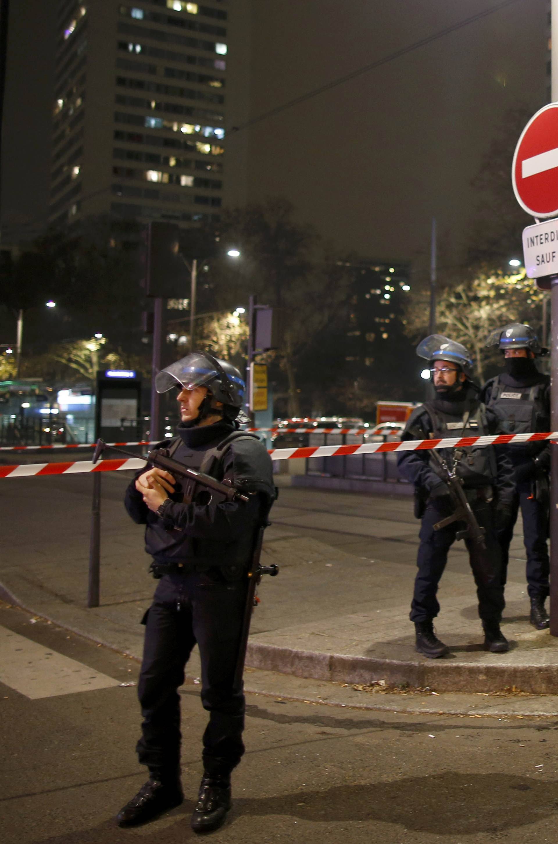 French police secure a street near the travel agency where a gunman has taken hostage about half a dozen people in what appears to be a robbery, a police source said, in Paris