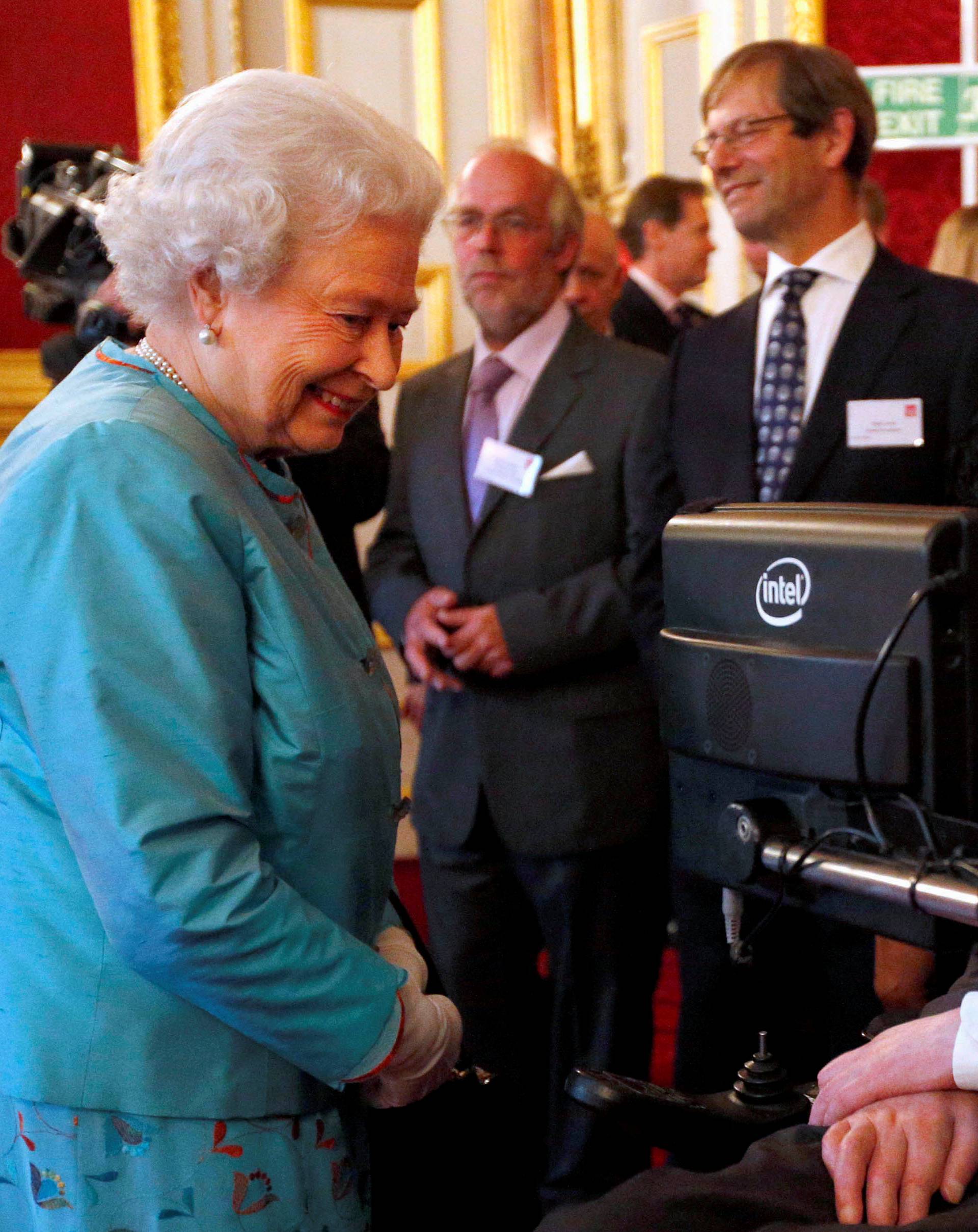 FILE PHOTO: Britain's Queen Elizabeth meets Hawking during reception for Leonard Cheshire Disability charity at St James's Palace in London