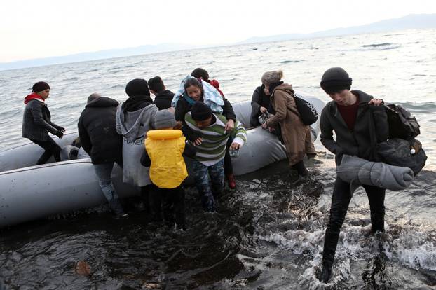 Migrants from Syria, Iraq, Afghanistan and Palestinian territories arrive on a dinghy near the city of Mytilene, after crossing part of the Aegean Sea from Turkey to the island of Lesbos