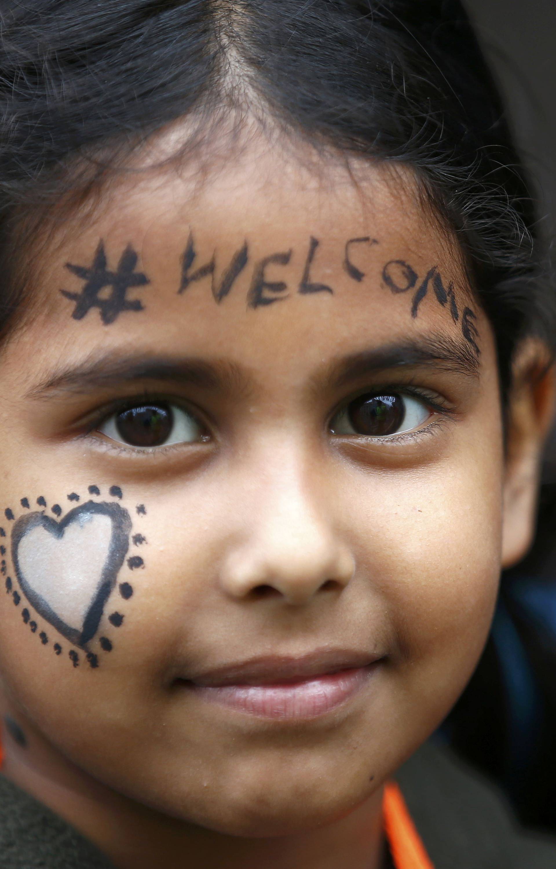 A demonstrator marches to the Houses of Parliament during a protest in support of refugees, in London