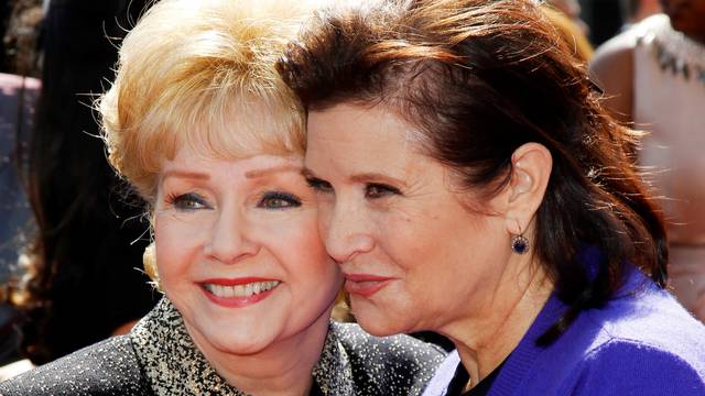 FILE PHOTO: Actress Debbie Reynolds and her daughter Carrie Fisher arrive at the 2011 Primetime Creative Arts Emmy Awards in Los Angeles
