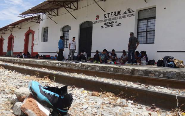 Central American migrants rest near a train track before continuing their journey to the U.S. despite U.S. President Donald Trump